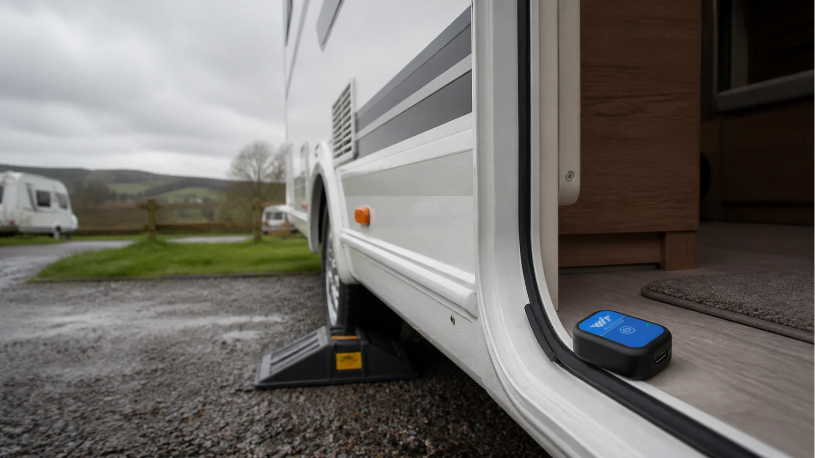 Caravan on a UK pitch with a compact IMU mounted for DIY pitch and roll levelling checks